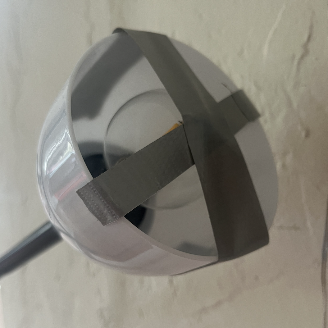 A too-small bulb taped to the inside of a lamp